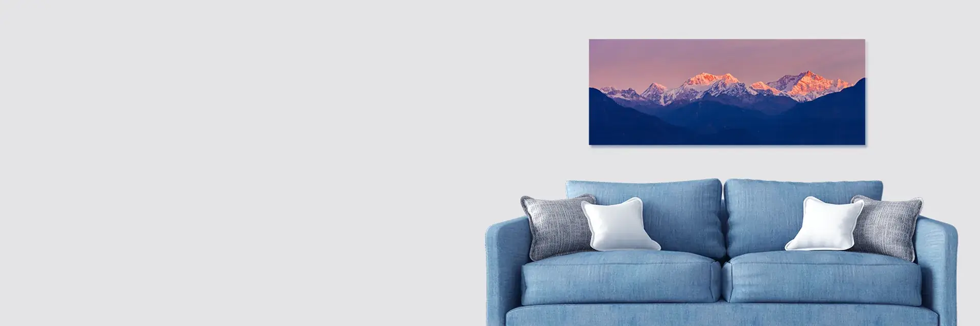 Panoramic mountain print hanging above a sofa