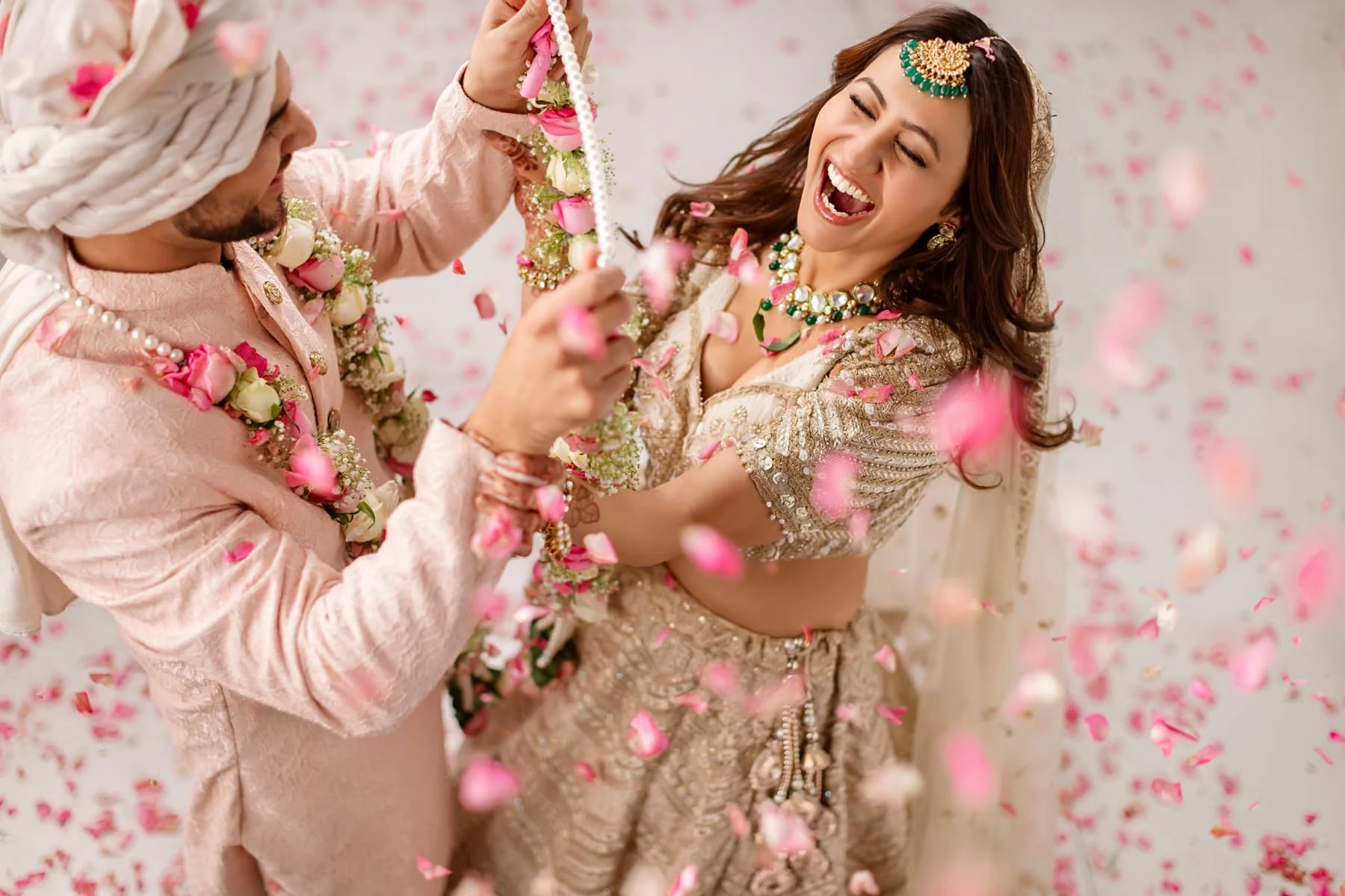 Couple laughing in falling petals
