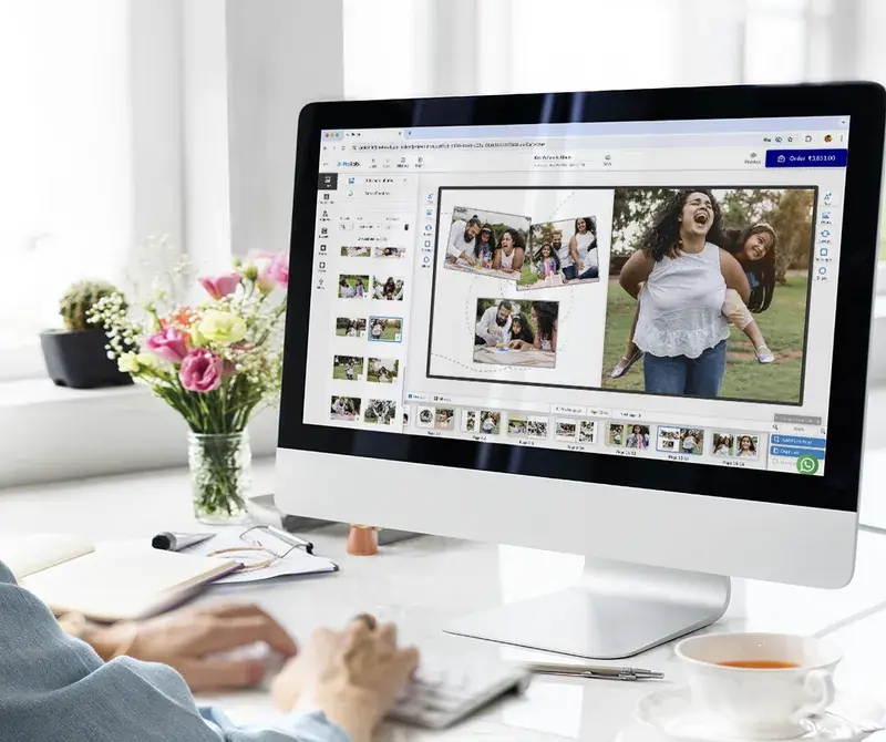 Photo book designer laying out an album on a computer